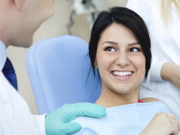 Woman sitting in dental chair as she is about to choose from our services