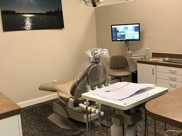 A treatment room featuring a comfortable dental chair